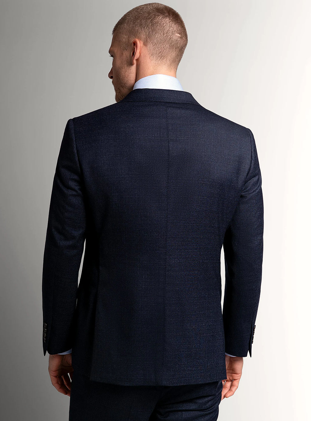 Shoulder and lapel detail of the navy jacket