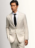 Cream sports jacket worn open over a pale shirt