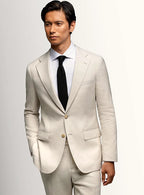Cream sports jacket worn open over a pale shirt
