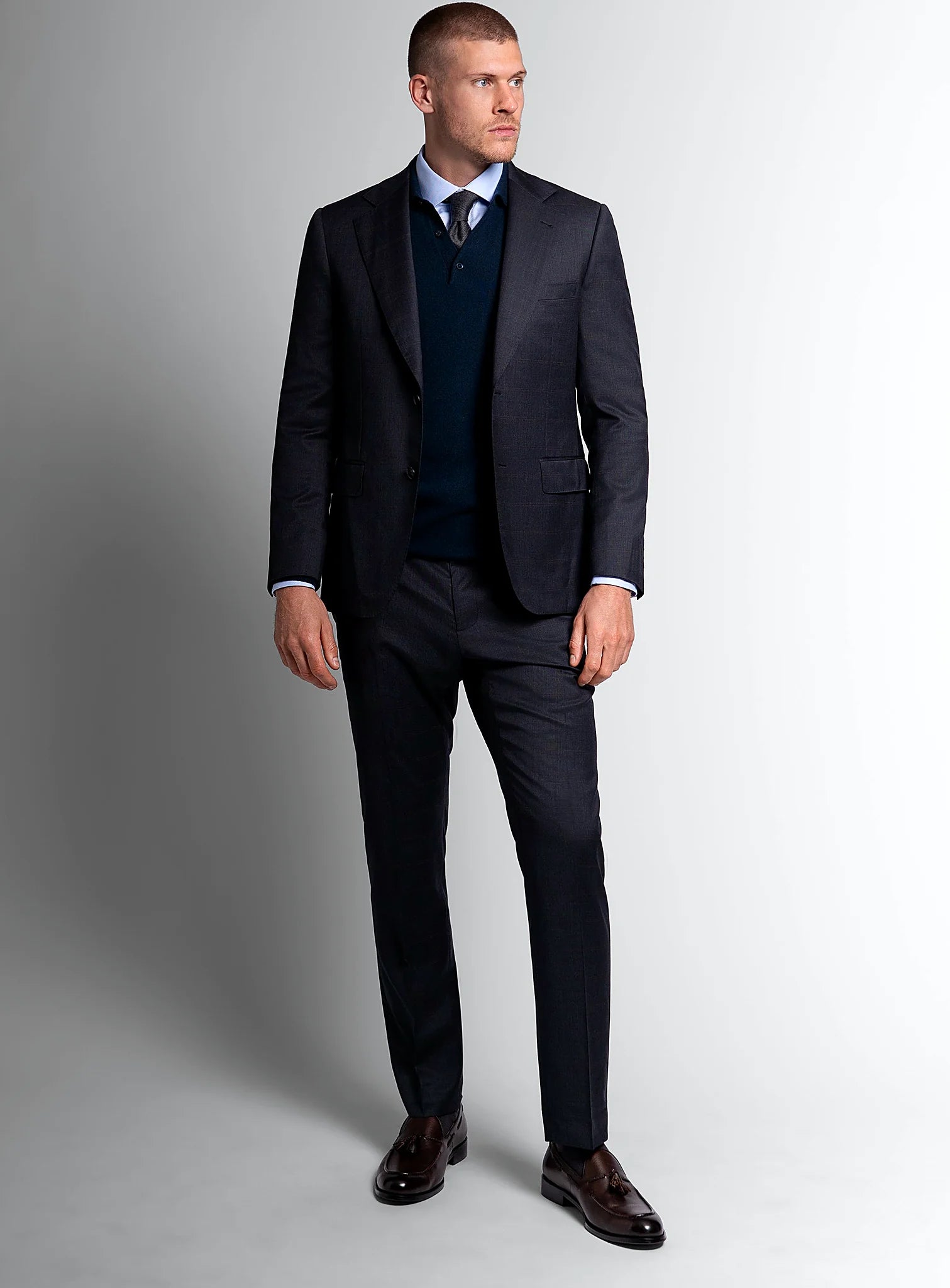 Three-quarter view of the navy jacket and trousers
